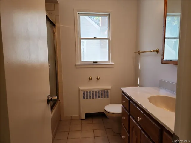 a bathroom with a sink a toilet and tub