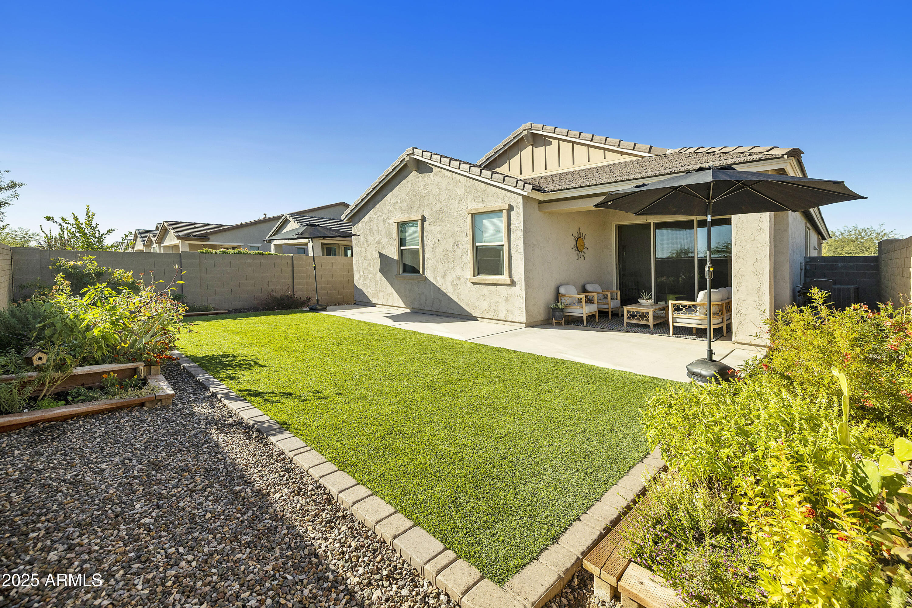 5813 South Del Rancho Mesa, AZ 85212 - Photo 28 of 47 a view of a house with a small yard and potted plants