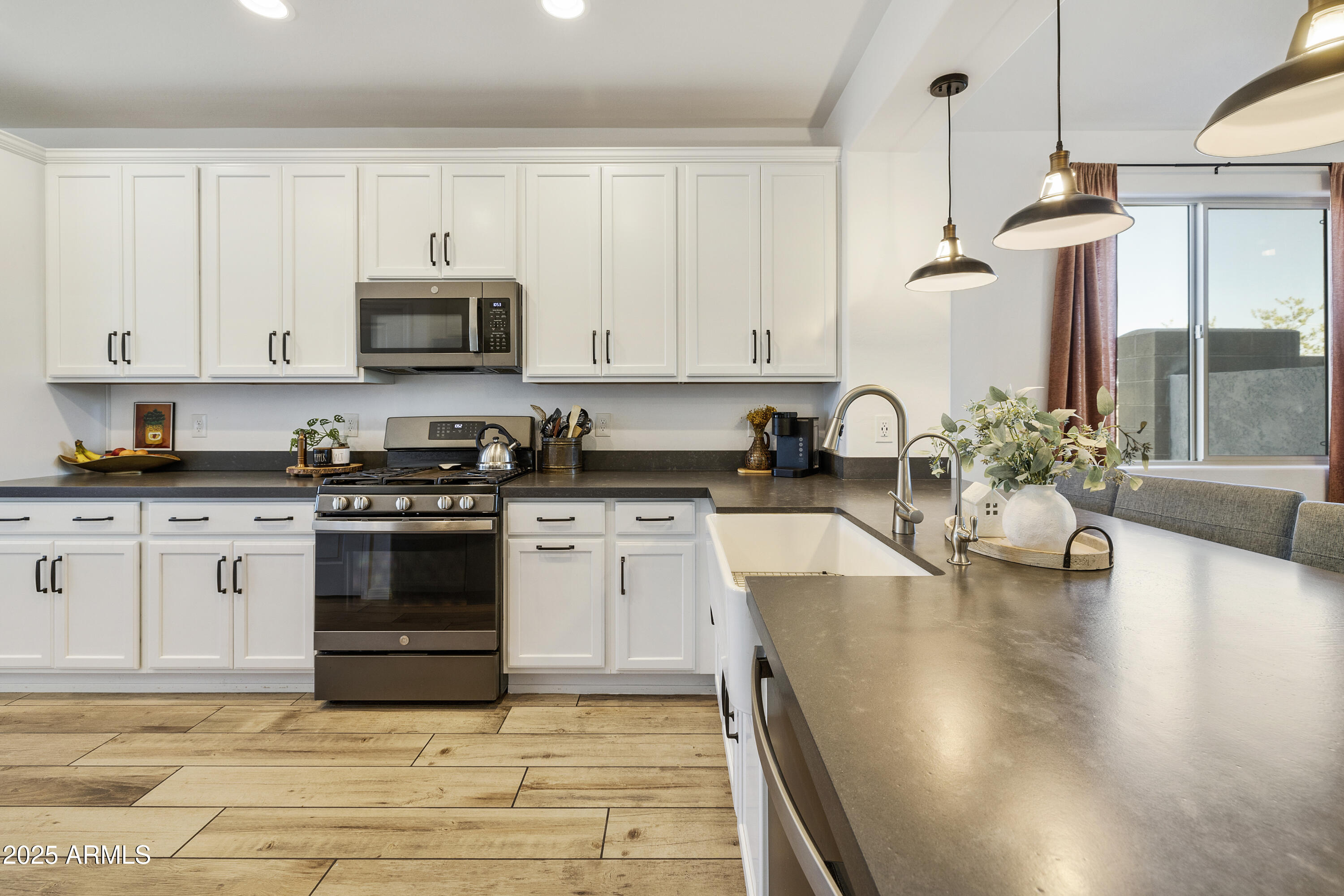 5813 South Del Rancho Mesa, AZ 85212 - Photo 4 of 47 a kitchen with granite countertop a stove a sink and a granite counter tops