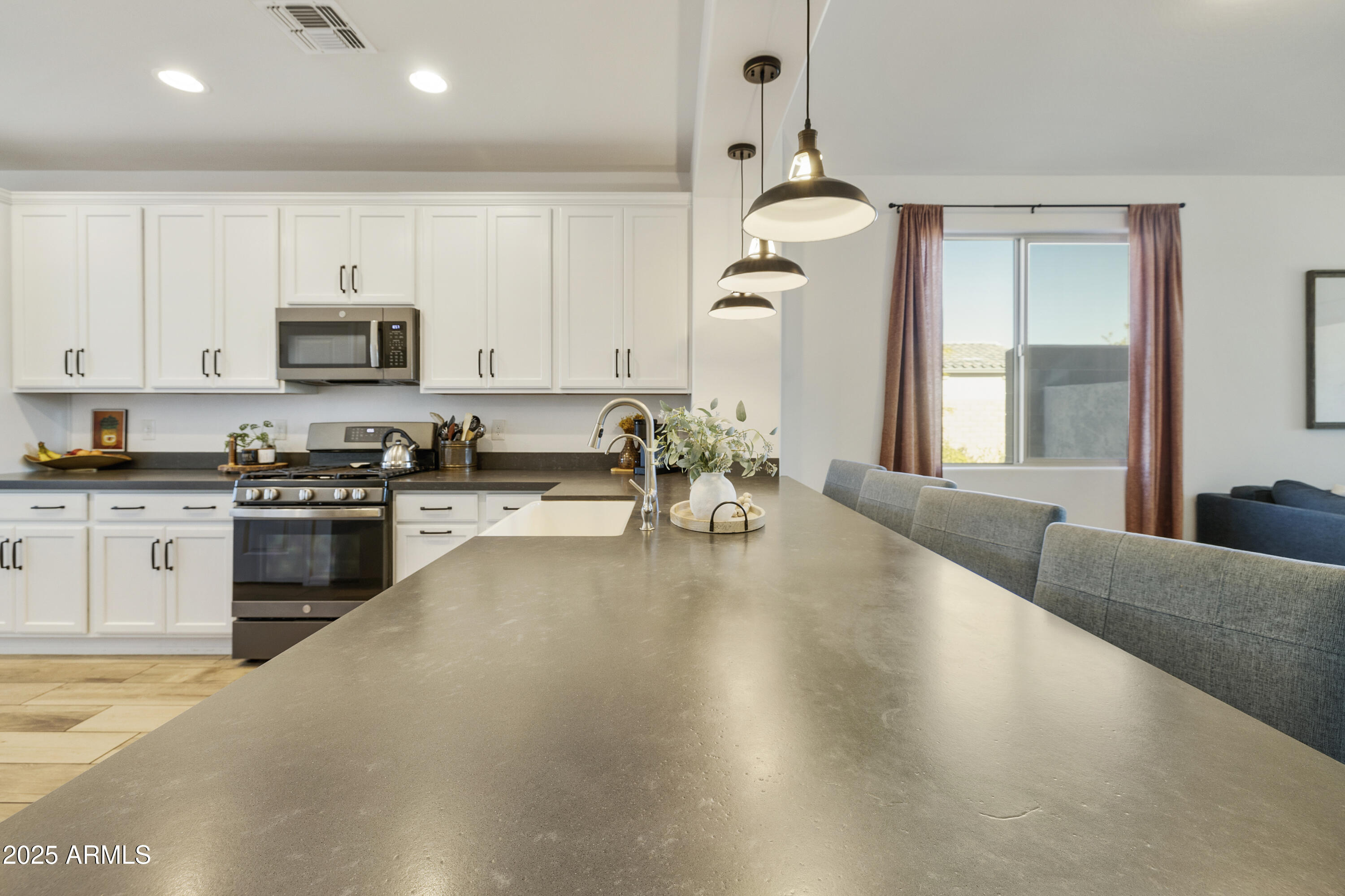5813 South Del Rancho Mesa, AZ 85212 - Photo 9 of 47 a kitchen with granite countertop a stove and a sink