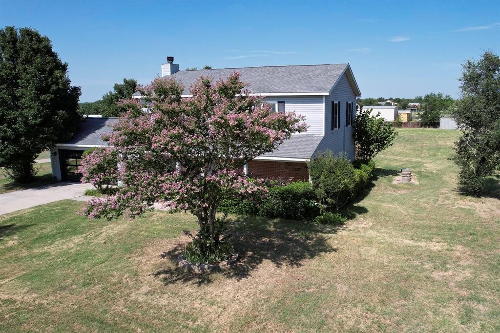 1766 Boss Range Road Justin, TX 76247 - Photo 11 of 35 a front view of a house with a yard and mountain view in back