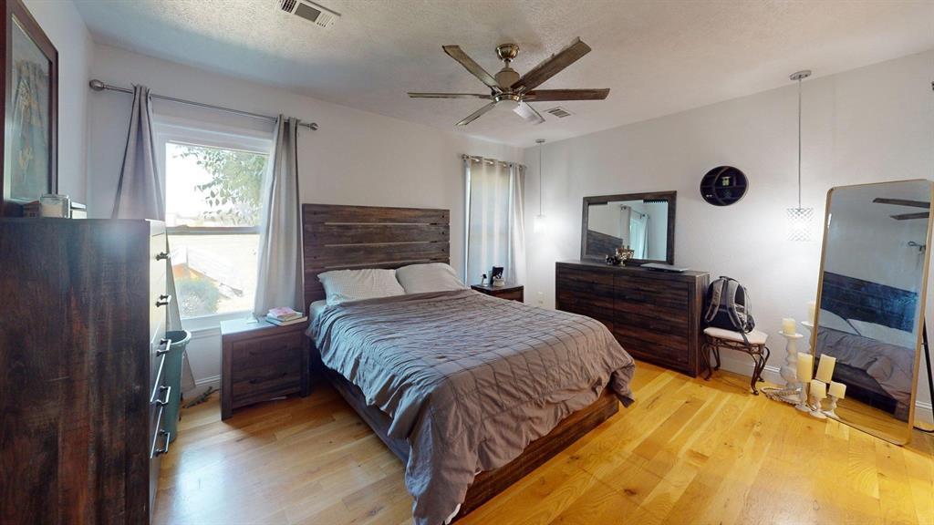 1766 Boss Range Road Justin, TX 76247 - Photo 19 of 35 a bed room with a bed and a tv