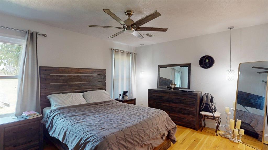 1766 Boss Range Road Justin, TX 76247 - Photo 22 of 35 a bedroom with a bed and a flat screen tv