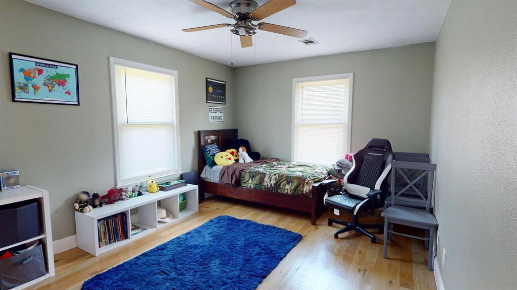 1766 Boss Range Road Justin, TX 76247 - Photo 28 of 35 a bedroom with furniture and a wooden floor