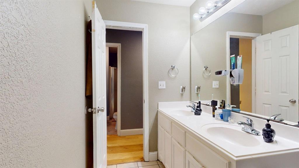 1766 Boss Range Road Justin, TX 76247 - Photo 31 of 35 a bathroom with a sink and a mirror