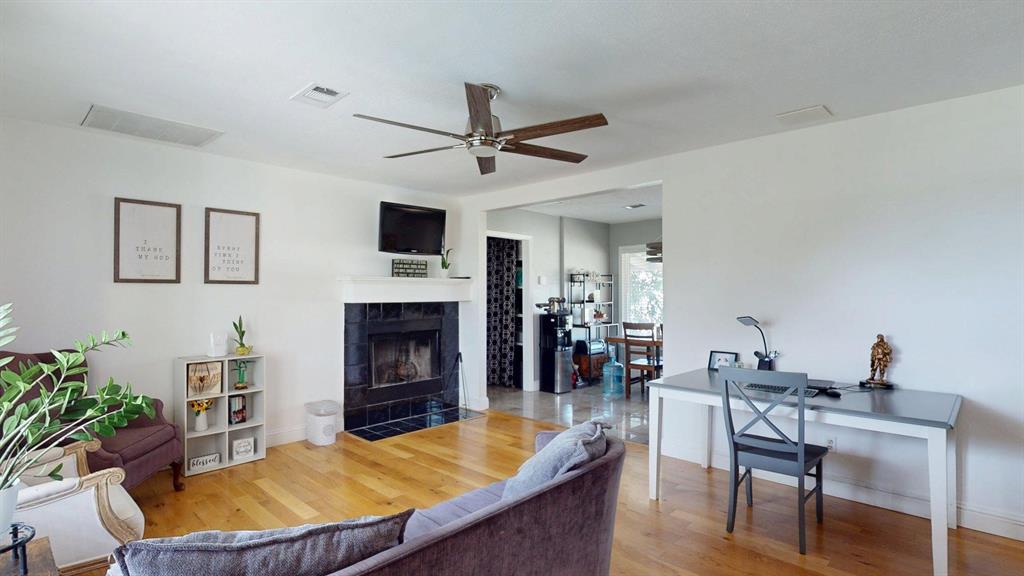 1766 Boss Range Road Justin, TX 76247 - Photo 10 of 35 a living room with furniture fireplace and a flat screen tv