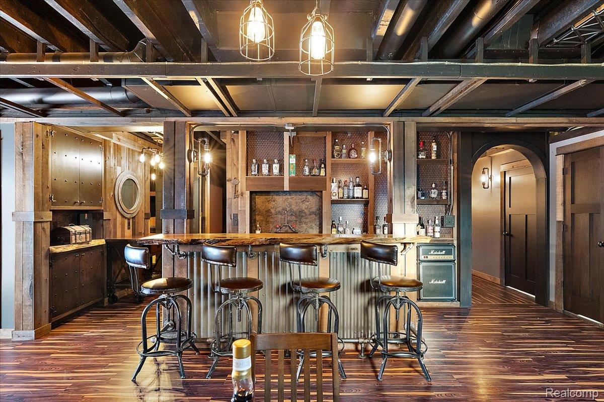 5035 Hidden Ridge Road Metamora, MI 48455 - Photo 49 of 65 Indoor wet bar featuring arched walkways, butcher block countertops, dark wood-style floors, and open shelves