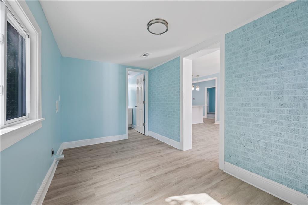 1658 Temple Avenue Atlanta, GA 30337 - Photo 14 of 27 a view of an empty room with wooden floor and window