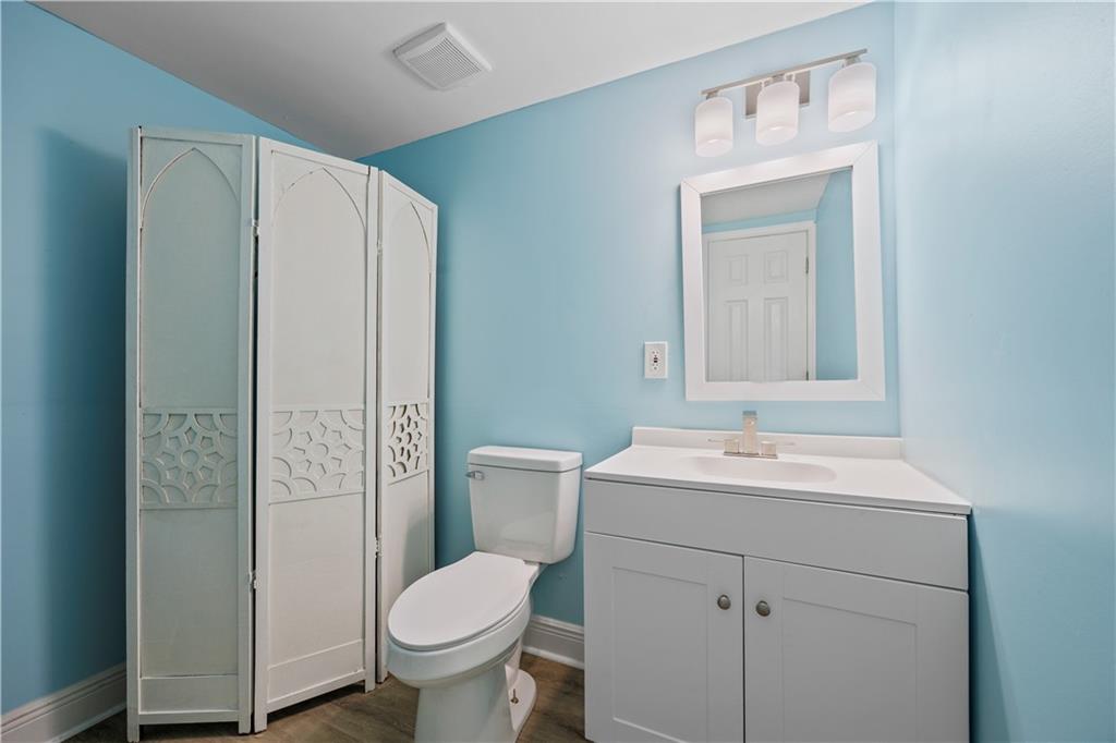 1658 Temple Avenue Atlanta, GA 30337 - Photo 16 of 27 a bathroom with a toilet sink vanity and mirror