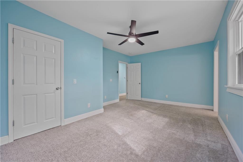 1658 Temple Avenue Atlanta, GA 30337 - Photo 19 of 27 a view of a livingroom with a ceiling fan & windows