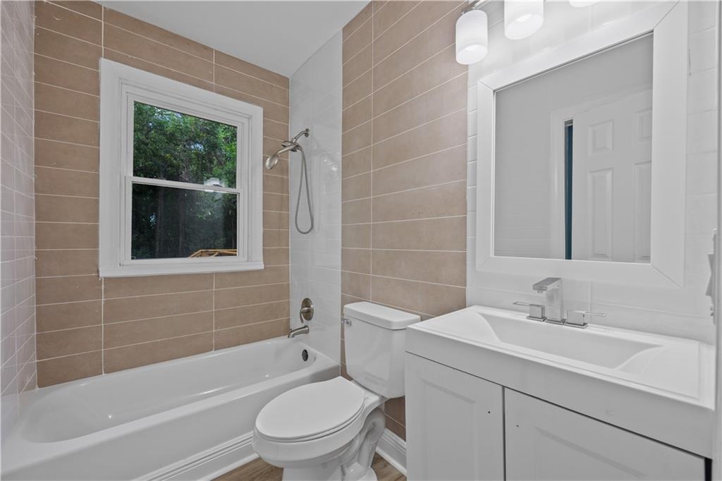 1658 Temple Avenue Atlanta, GA 30337 - Photo 24 of 27 a bathroom with a sink toilet and shower