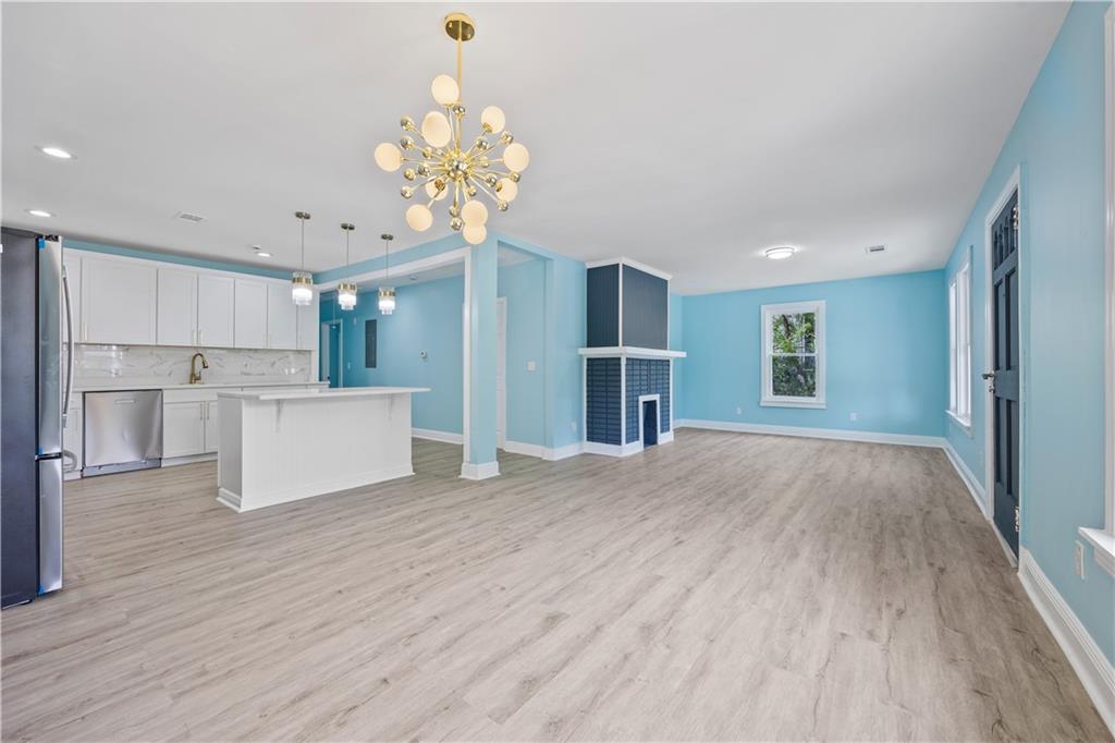1658 Temple Avenue Atlanta, GA 30337 - Photo 5 of 27 a view of a kitchen with a sink and refrigerator
