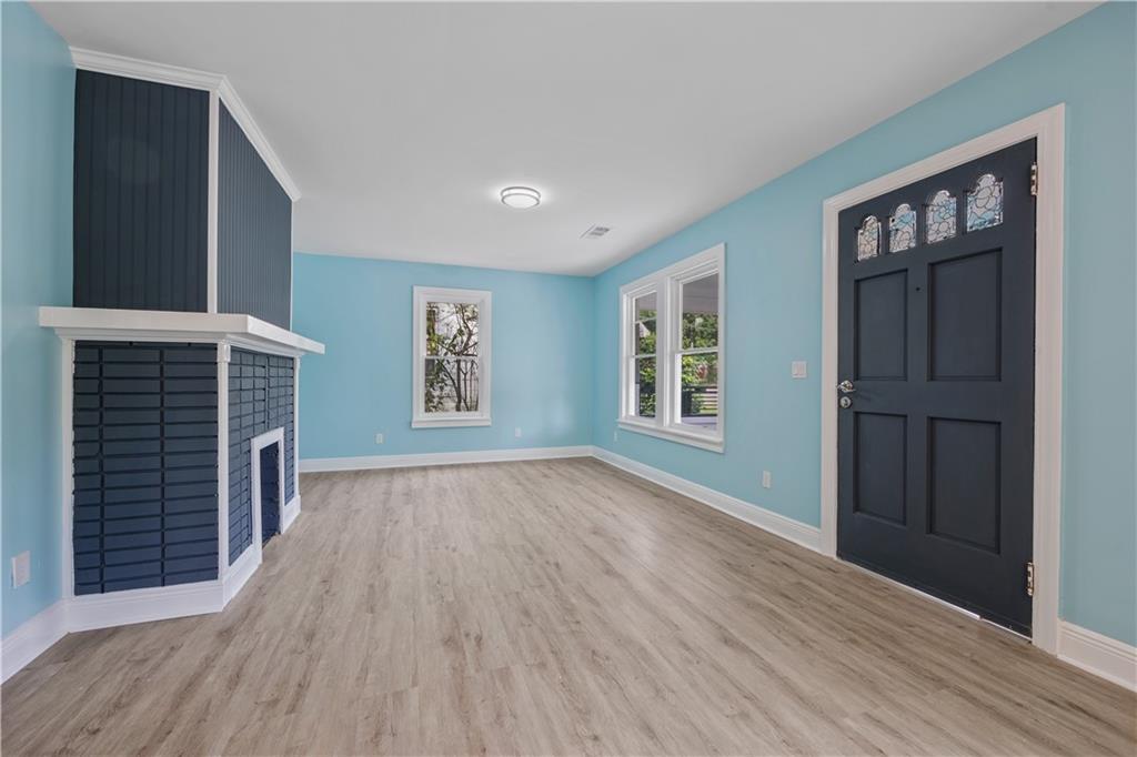 1658 Temple Avenue Atlanta, GA 30337 - Photo 6 of 27 a view of empty room with wooden floor and fan
