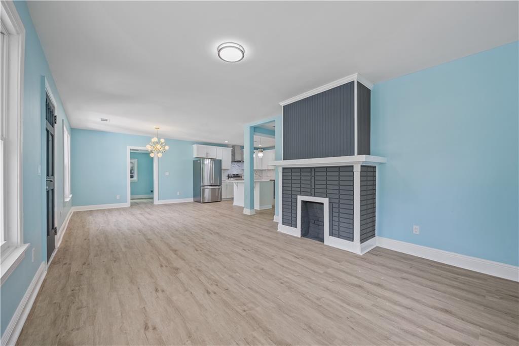 1658 Temple Avenue Atlanta, GA 30337 - Photo 7 of 27 a view of a livingroom with wooden floor and a fireplace