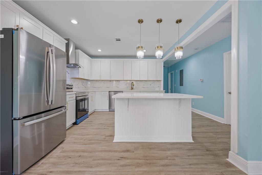 1658 Temple Avenue Atlanta, GA 30337 - Photo 8 of 27 a large kitchen with cabinets and stainless steel appliances