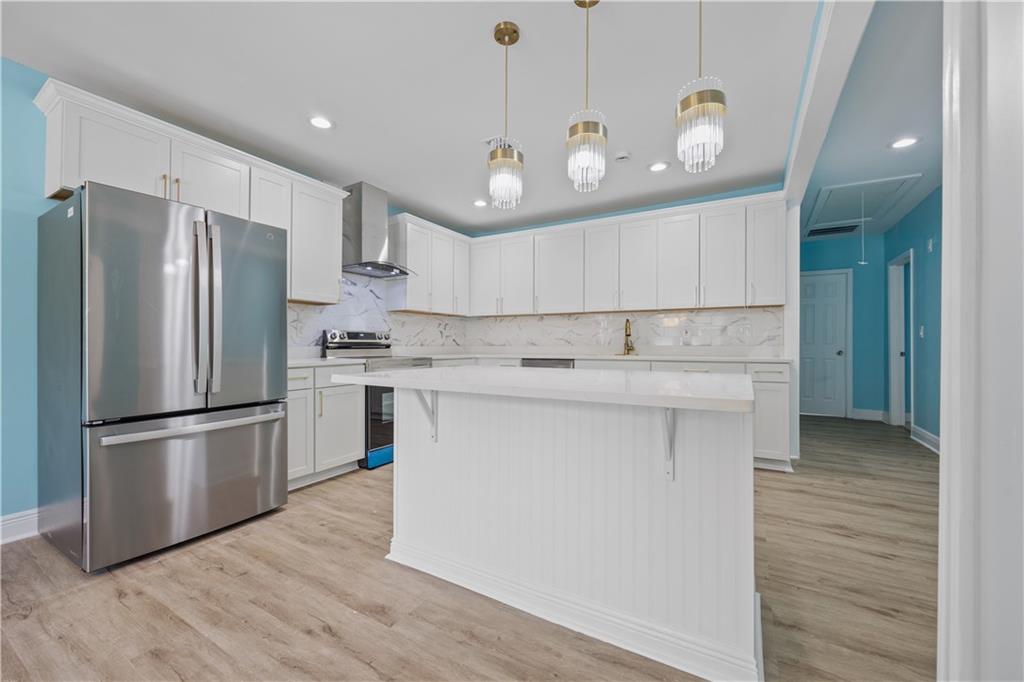 1658 Temple Avenue Atlanta, GA 30337 - Photo 9 of 27 a kitchen with kitchen island white cabinets and stainless steel appliances