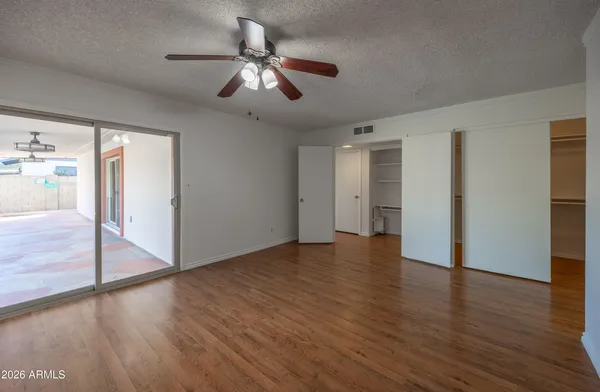 a view of an empty room with wooden floor