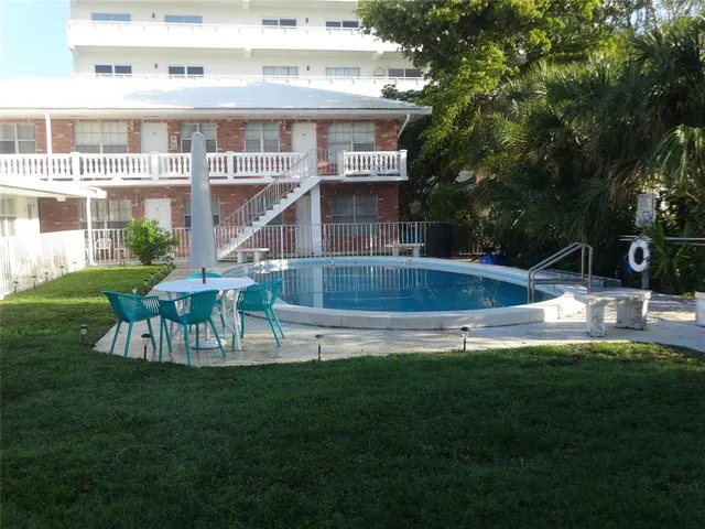 a view of a house with a yard deck and sitting area