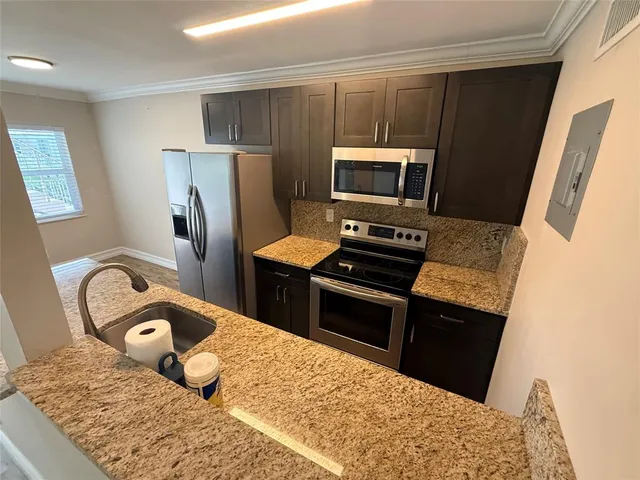 a kitchen with a refrigerator and a stove