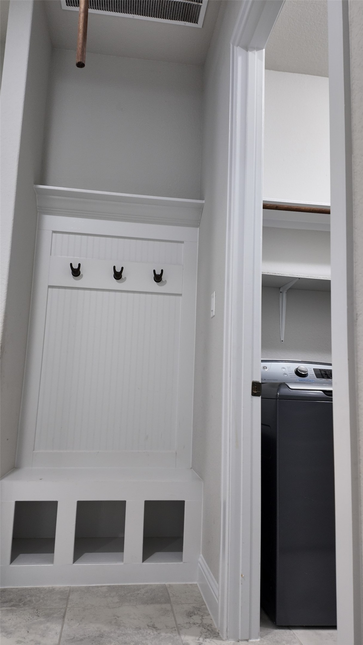 2320 Base Burner Path Leander, TX 78641 - Photo 14 of 24 A clever laundry area with built-in storage and a convenient coat rack keeps clutter at bay.