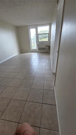 an empty room with a empty space and window