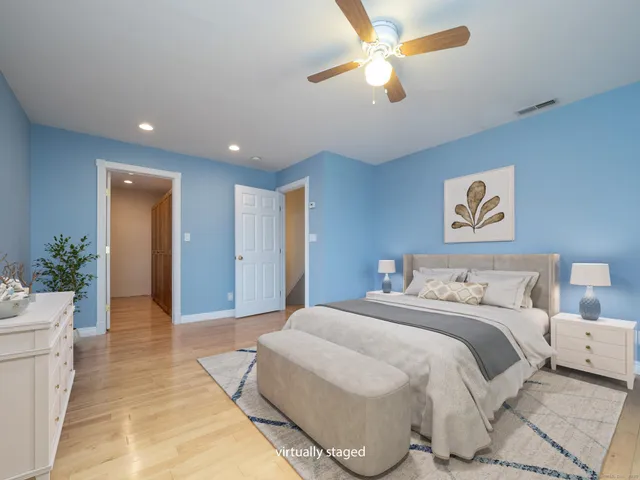 a spacious bedroom with a bed and a chandelier