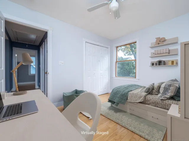 a bedroom with a bed and a large window