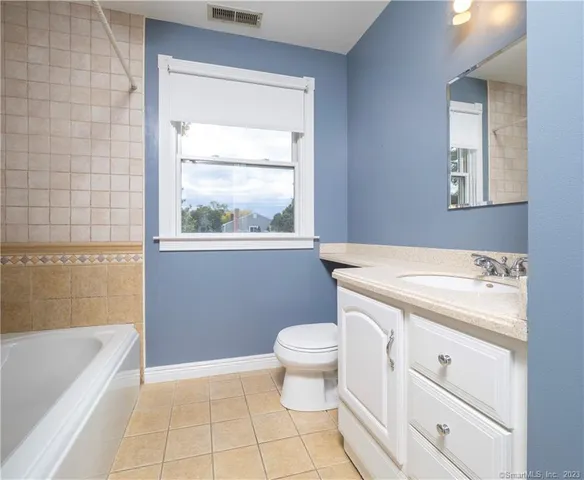 a bathroom with a sink a toilet and a bathtub