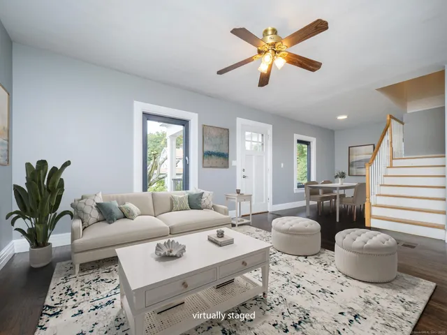 a living room with furniture and a potted plant
