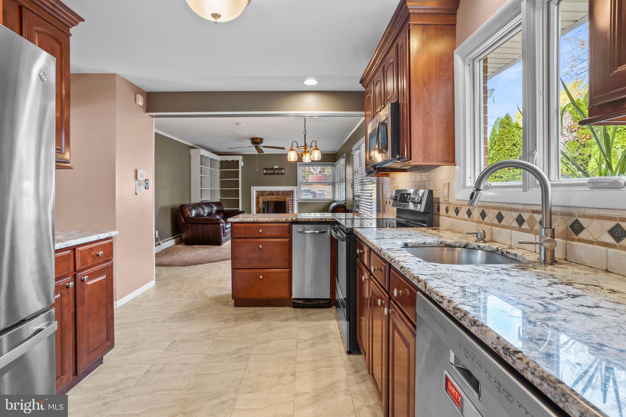 504 Minshall Road Springfield, PA 19064 - Photo 12 of 39 a large kitchen with stainless steel appliances granite countertop a large stove a sink dishwasher a refrigerator and a stove