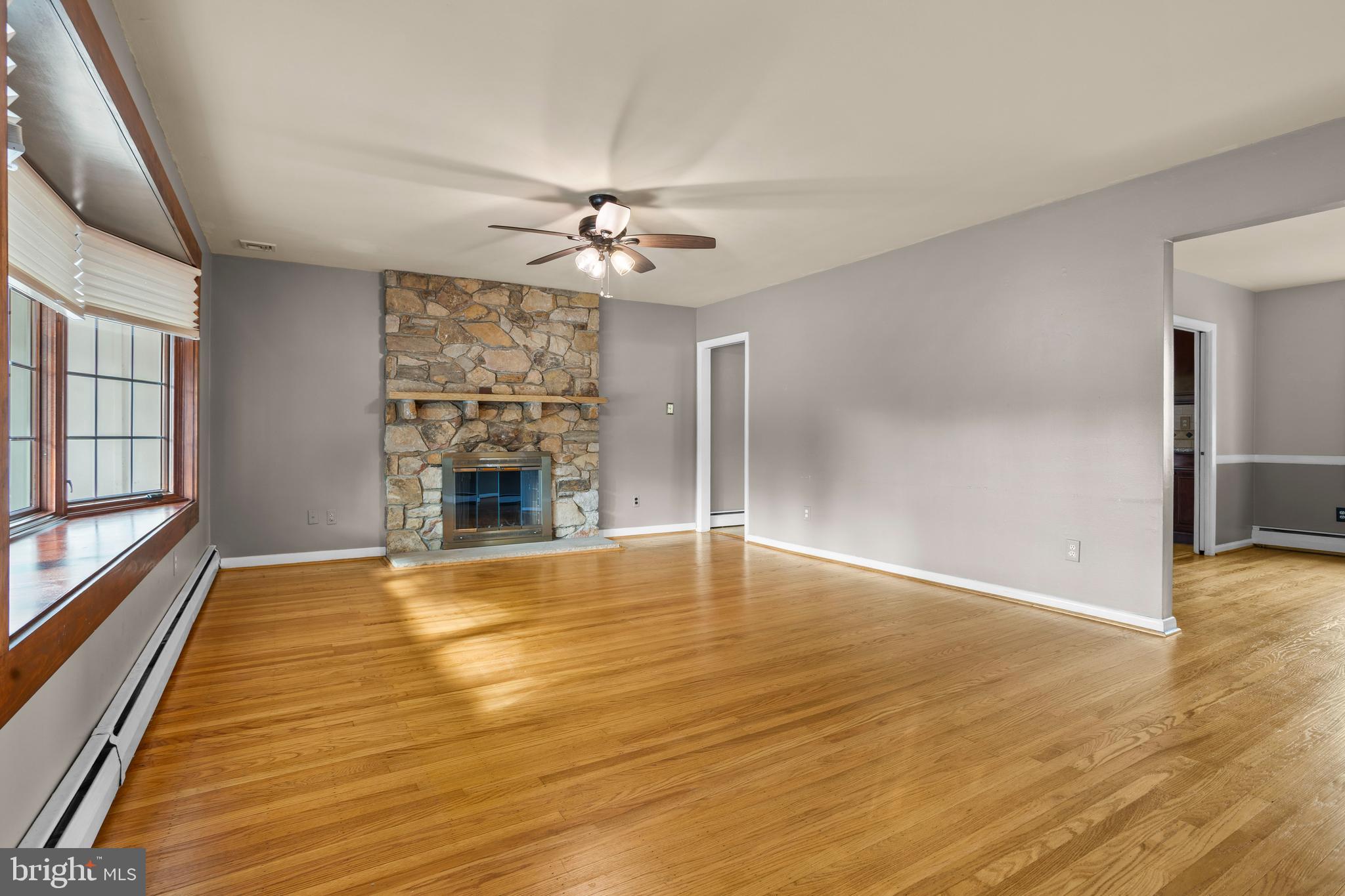 504 Minshall Road Springfield, PA 19064 - Photo 5 of 39 a view of an empty room with a fireplace and a window