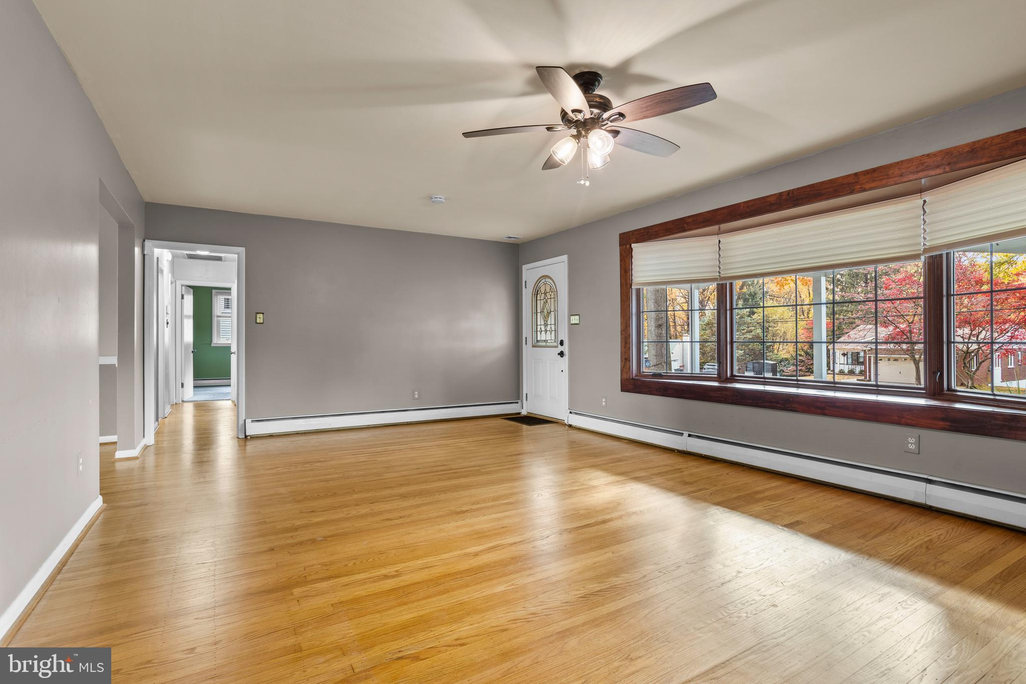 504 Minshall Road Springfield, PA 19064 - Photo 7 of 39 a view of an empty room with chandelier fan and wooden floor