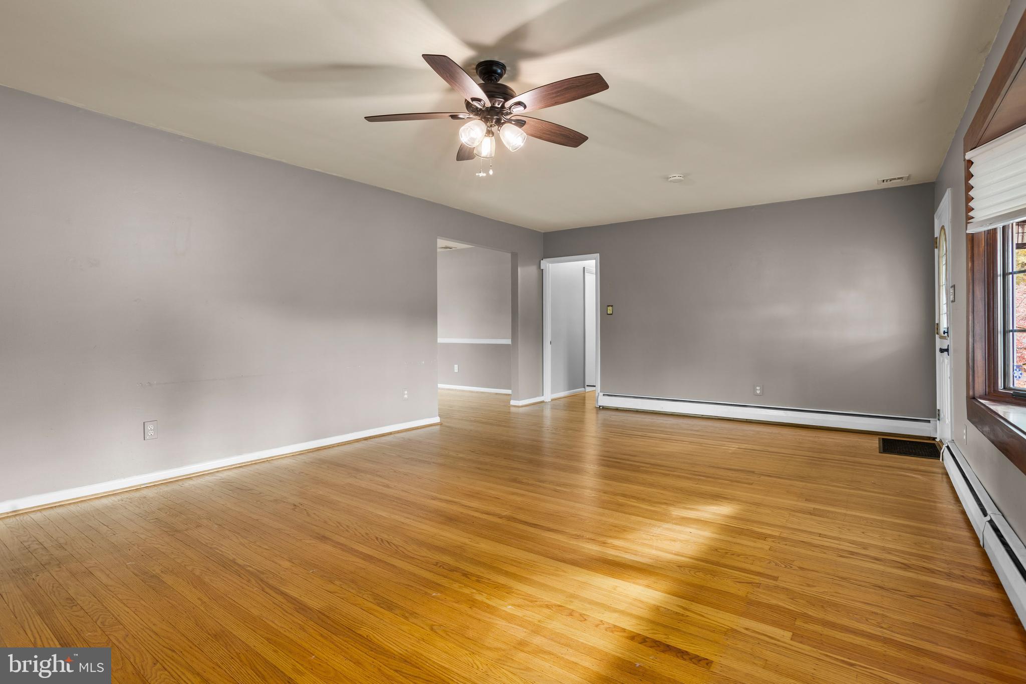 504 Minshall Road Springfield, PA 19064 - Photo 8 of 39 an empty room with wooden floor and fan