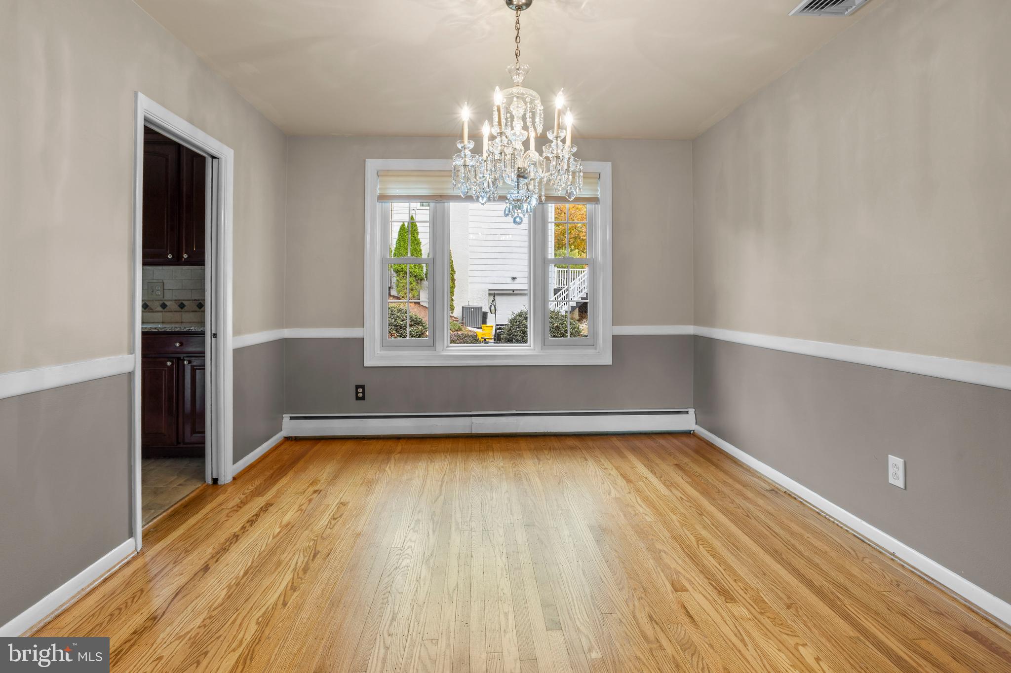 504 Minshall Road Springfield, PA 19064 - Photo 9 of 39 a view of a room with window wooden floor and chandelier