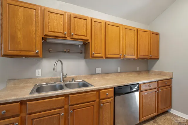 a kitchen with stainless steel appliances granite countertop a refrigerator sink and stove