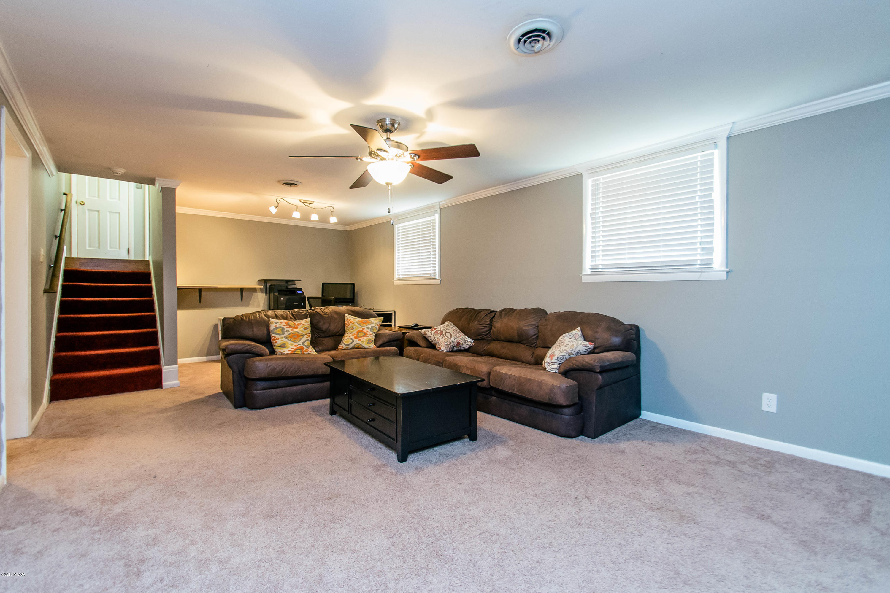 1403 Cambridge Road Perry, GA 31069 - Photo 15 of 38 a living room with furniture and a chandelier