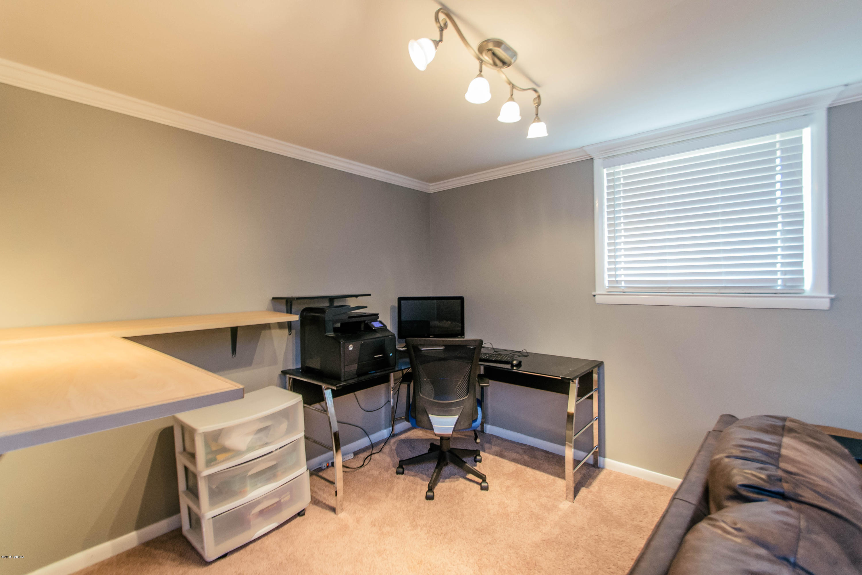 1403 Cambridge Road Perry, GA 31069 - Photo 17 of 38 a view of a workspace with furniture and a window