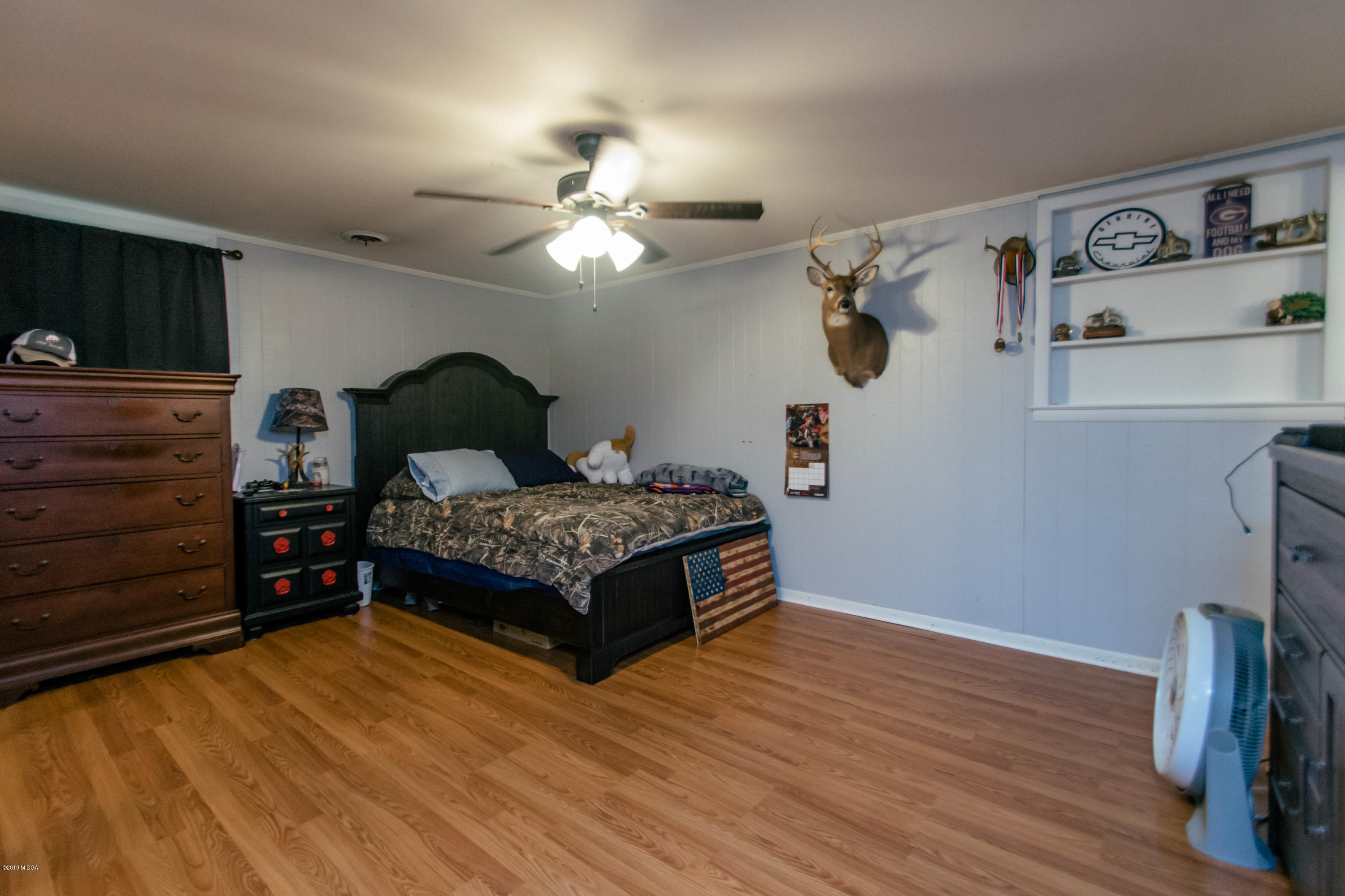 1403 Cambridge Road Perry, GA 31069 - Photo 21 of 38 a bedroom with a bed and wooden floor
