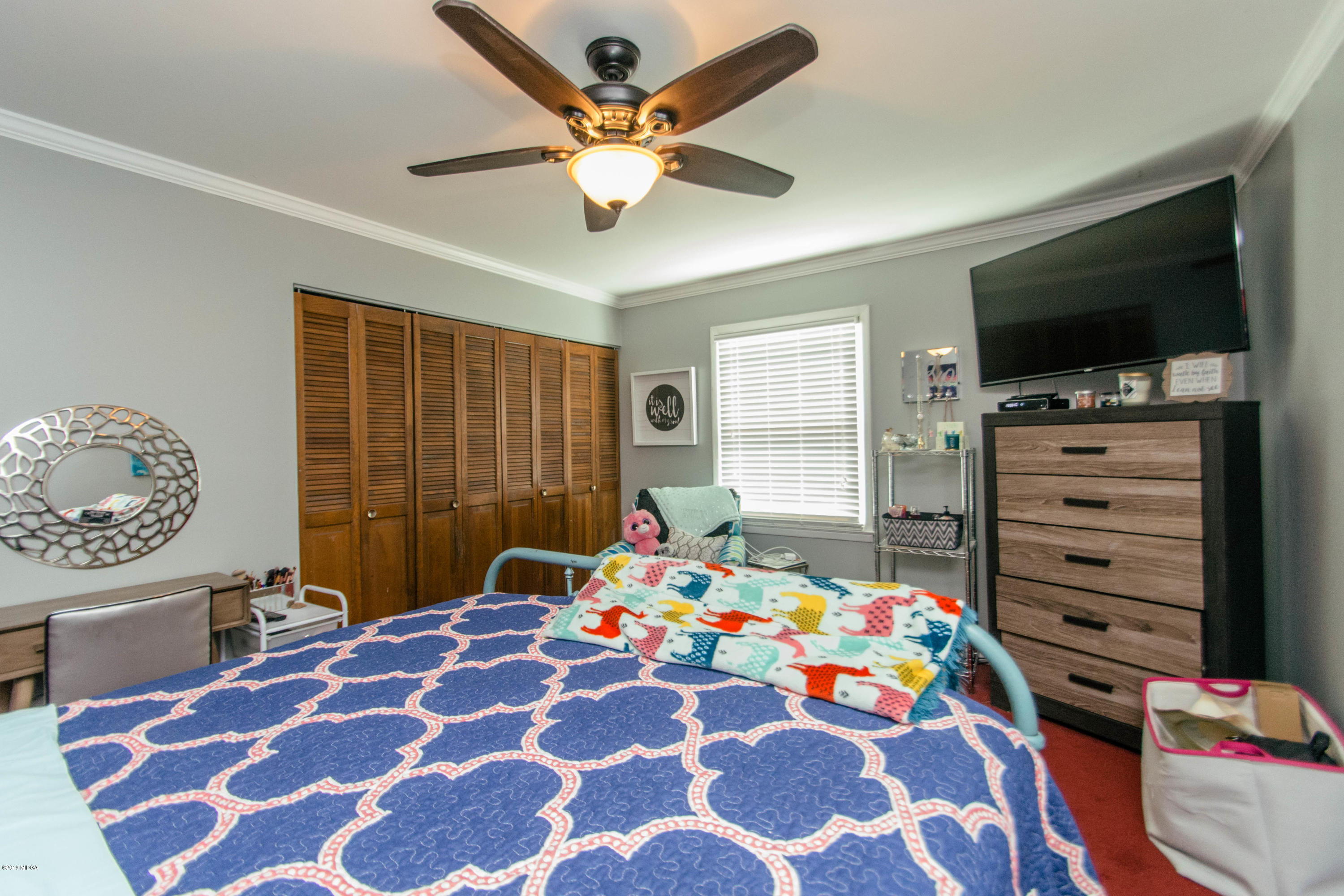 1403 Cambridge Road Perry, GA 31069 - Photo 25 of 38 a bedroom with a bed window and a flat screen tv