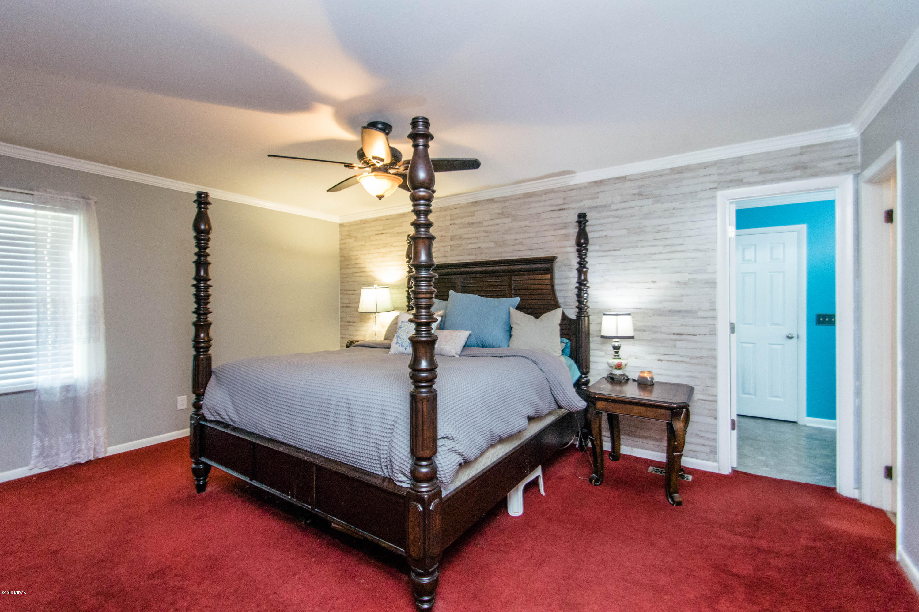 1403 Cambridge Road Perry, GA 31069 - Photo 26 of 38 a bedroom with a bed and a chandelier