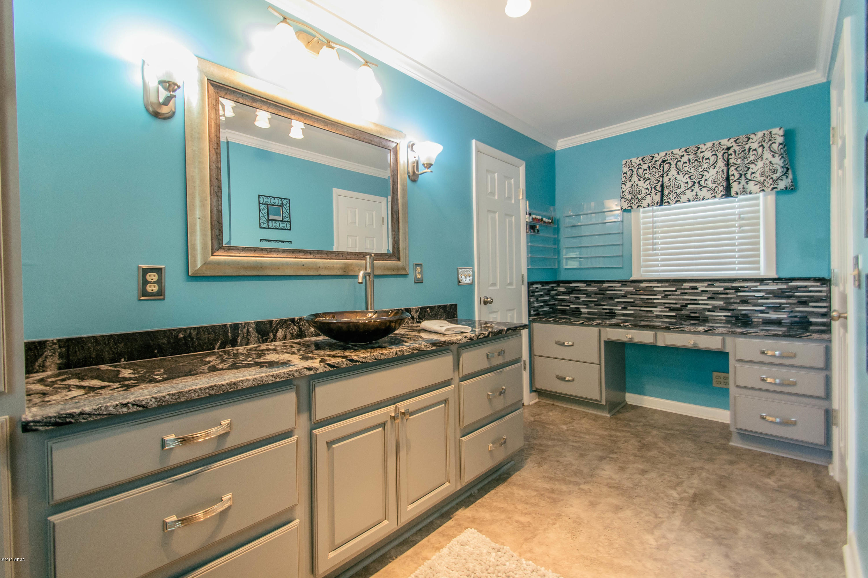1403 Cambridge Road Perry, GA 31069 - Photo 28 of 38 a bathroom with a granite countertop sink and a mirror