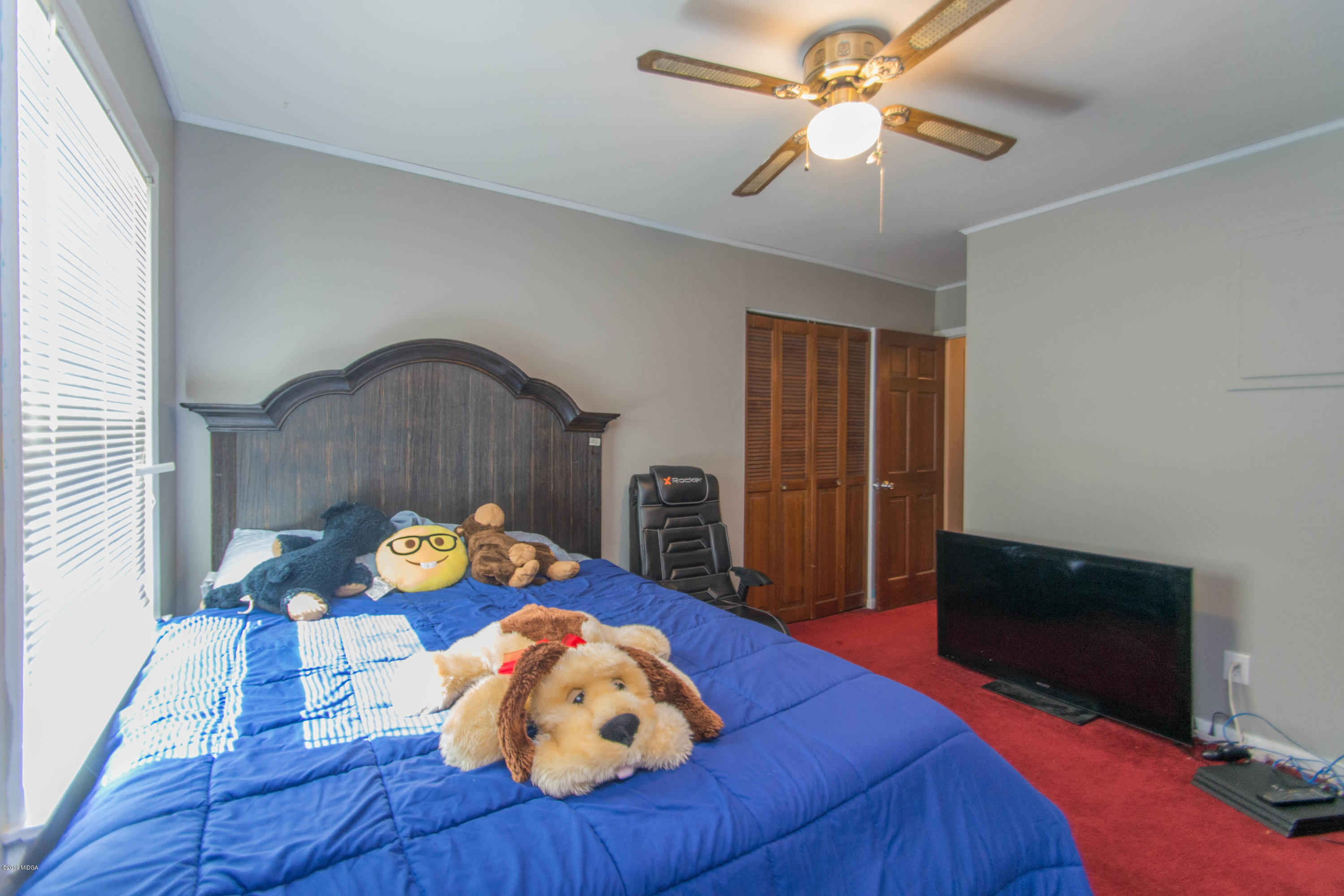 1403 Cambridge Road Perry, GA 31069 - Photo 33 of 38 a living room with furniture and a flat screen tv