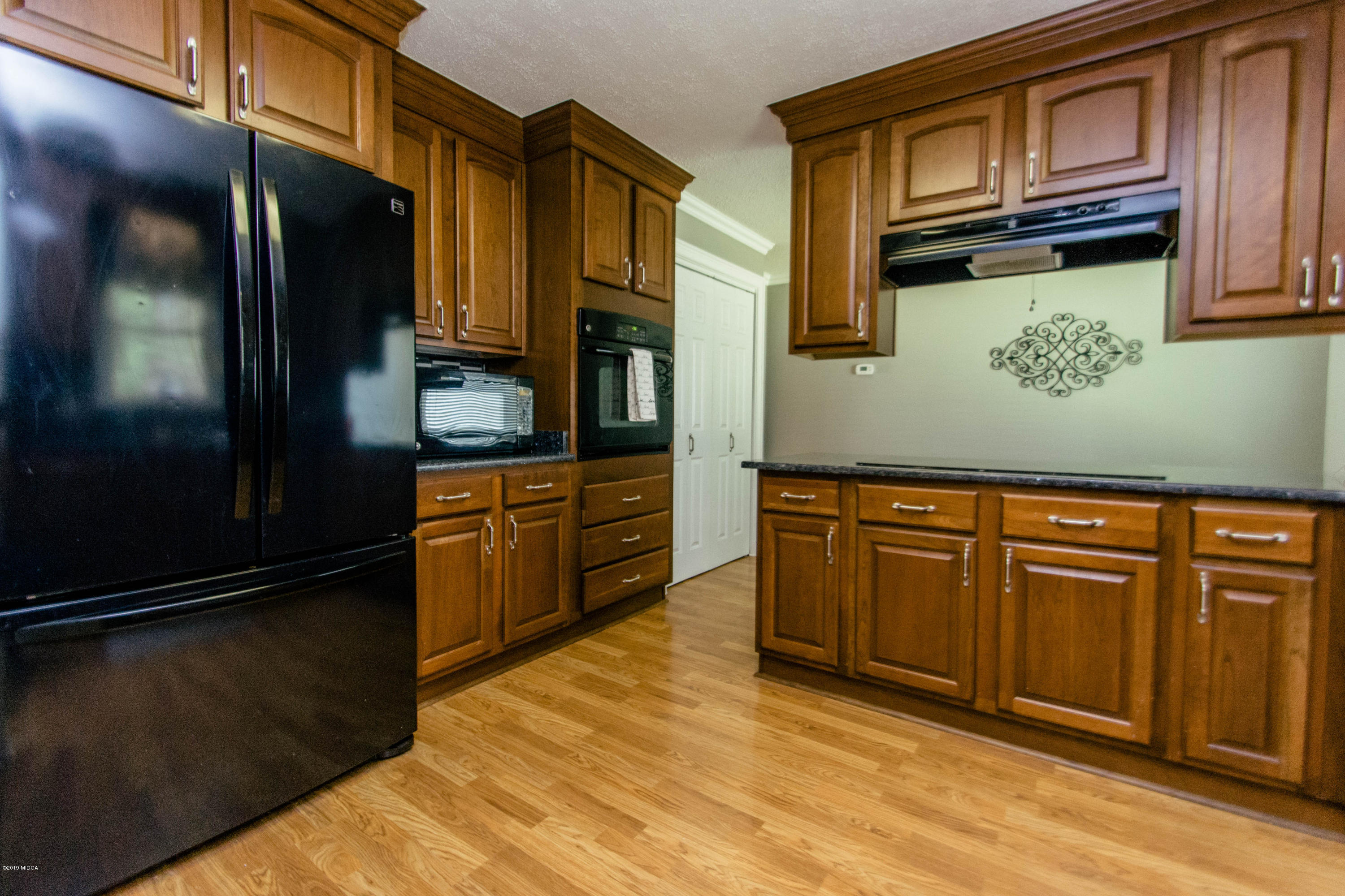 1403 Cambridge Road Perry, GA 31069 - Photo 9 of 38 a kitchen with stainless steel appliances granite countertop a refrigerator and a sink