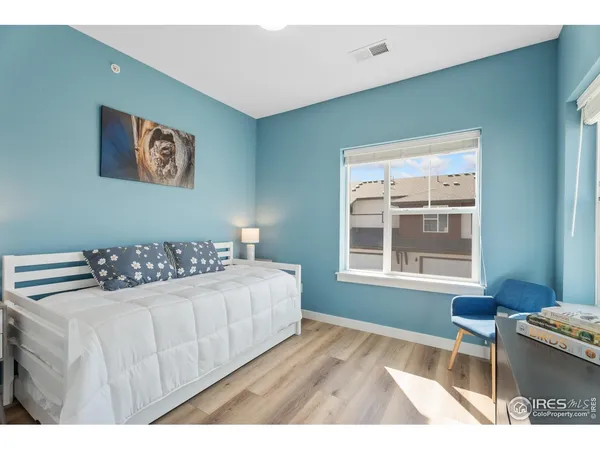 a bedroom with a large bed and a window
