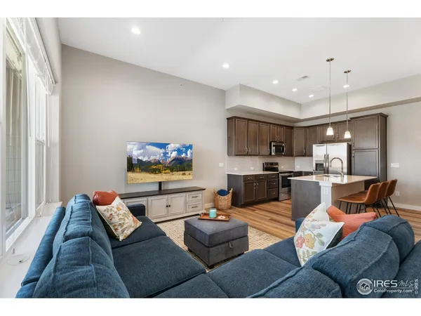 a living room with furniture kitchen and a window