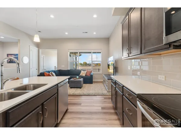 a kitchen with a stove a refrigerator and a microwave