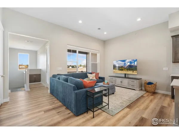 a living room with furniture and kitchen view