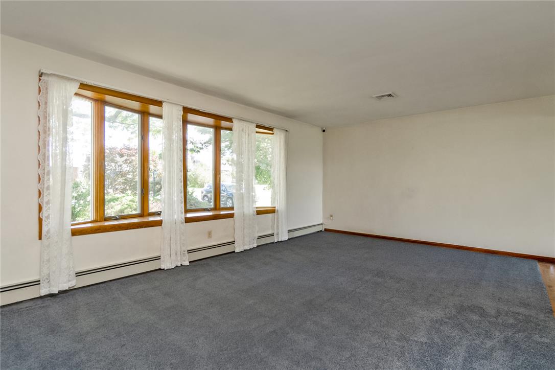 1657 Clearview Road Coplay, PA 18037 - Photo 33 of 77 A spacious living room featuring large bay windows overlooking verdant outdoor surroundings.