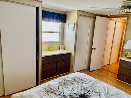 a bedroom with a bed and a dresser