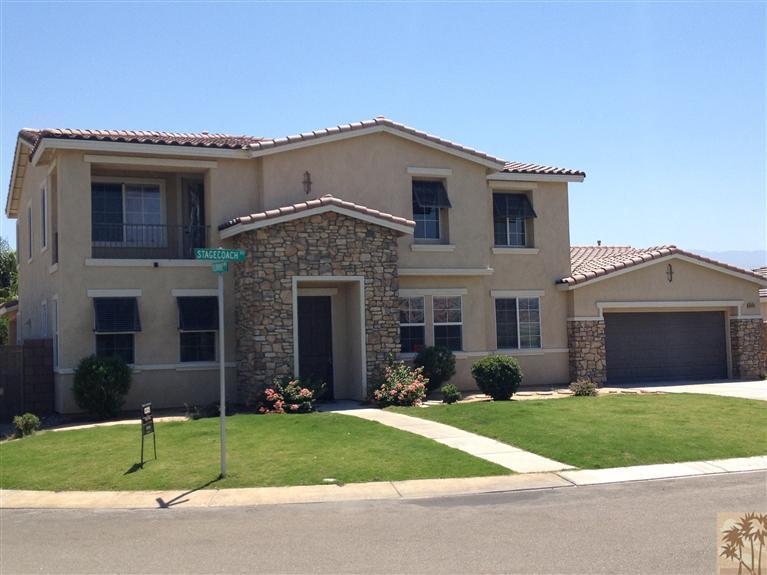 83449 Stagecoach Road Indio, CA 92203 - Photo 1 of 16 a front view of a house with a garden and yard
